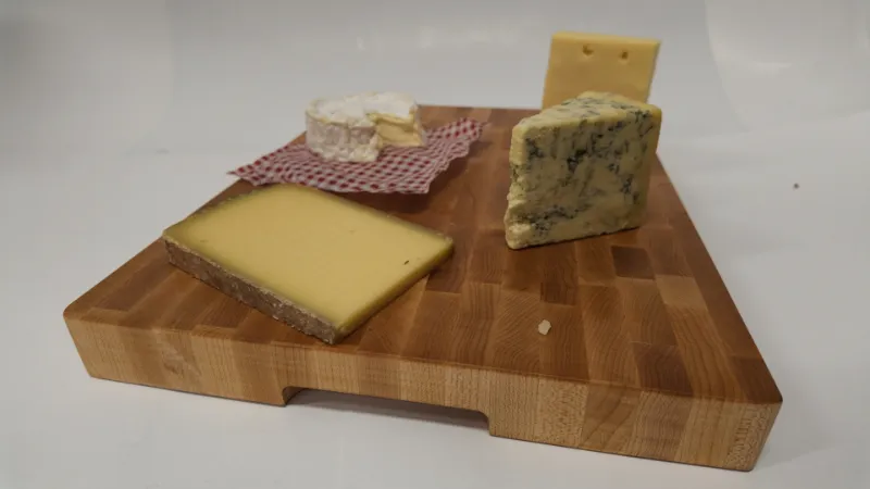 Cloumann end-grain maple board used as a personalised cheese board, with Brie, Stilton and hard Alpine cheese