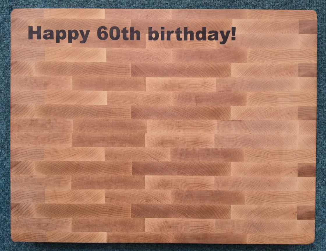 Personalised end-grain maple chopping board engraved with Happy 60th birthday!