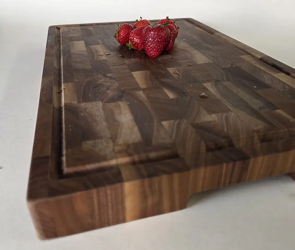 Cloumann end-grain walnut chopping board with juice groove, topped with fresh strawberries